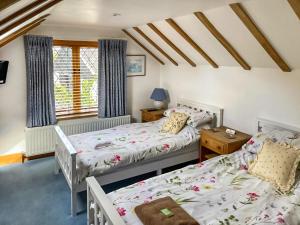 a bedroom with two beds and a window at Rumbolds Retreat in Plaistow