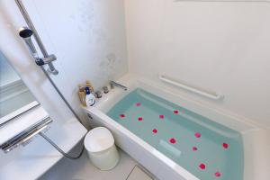 a bathroom with a bath tub with red hearts on it at BBQ可/庭付き一棟貸/ビーチまで3分/古宇利島車で7分/最大8人 Luana house in Nago