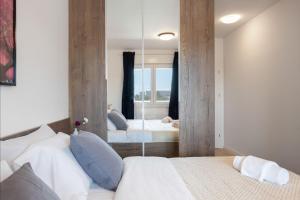 a bedroom with two beds and a large mirror at Stylish 2BDR Apartment- Free Garage in Zagreb +29 photos