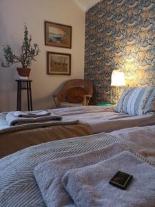 a hotel room with two beds with a book on it at Disponentparken Café och Bed & Breakfast in Grängesberg