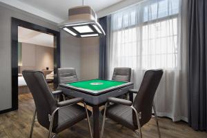 a conference room with a table and chairs and a mirror at Unitour Hotel, Xiangxiang Dongfeng Square in Xiangxiang