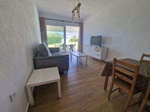 a living room with a couch and a table at Casas Miramar in Tarifa