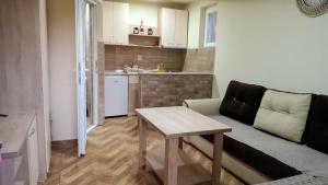 a small living room with a table and a couch at Villa & Apartments Petkoski in Ohrid