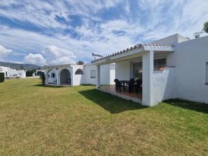 a white house with a lawn in front of it at Casas Miramar in Tarifa