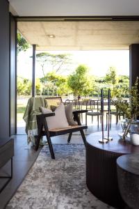 a living room with couches and a large window at The Woods Luxury Homes - Elaleni Estate in Ballito