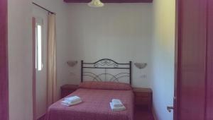 a bedroom with a bed with two towels on it at Casas Miramar in Tarifa +65 photos