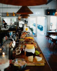 a buffet line with many different types of food at STF Korrö Hotell in Linneryd