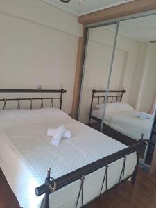 a bedroom with two beds and a mirror at Ηome Rent Chalkida in Kánithos