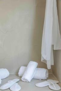 a group of white towels sitting on a counter at Nikole cottage house by the sea in Kokkini Khanion