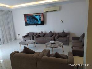 a living room with two couches and two tables at Salalah Beach Villas in Salalah