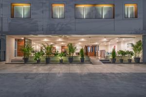 SKYLA Serviced Apartments & Suites, Hi-Tech City في حيدر أباد: مبنى به نباتات الفخار في ساحة الفناء