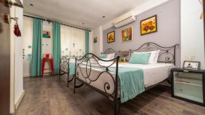 a bedroom with a bed with a metal frame at Bertiz Mignon in Bozcaada