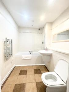 a white bathroom with a toilet and a sink at The Works-Fresh 2bed in centre, opposite Arndale. in Manchester +17 photos