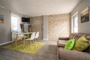 a living room with a couch and a table at FeWo 1 ''Am Rodelberg'' in Priborn