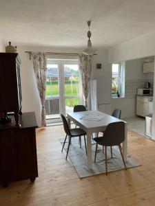 a kitchen and dining room with a table and chairs at Apartmán Spolí in Třeboň +5 photos