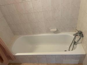 a white bath tub with a faucet in a bathroom at Apartmán Spolí in Třeboň