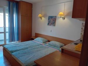 a small bedroom with a bed and a window at Vila Centar in Trebinje