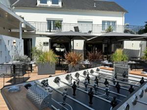 a game of chess on the patio of a house at Logis Hôtel & Restaurant Le Vert Bocage in Franqueville-Saint-Pierre