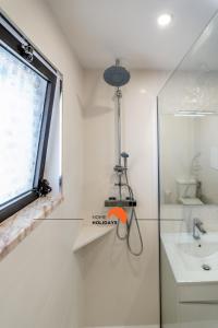 a bathroom with a shower and a sink and a window at #169 T3 Medronheira by Home Holidays in Olhos de Água