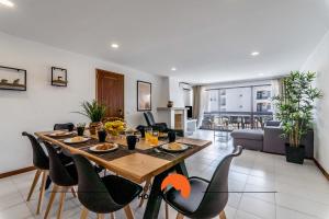 a dining table and chairs in a living room at #169 T3 Medronheira by Home Holidays in Olhos de Água