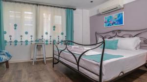 a bedroom with a metal bed in a room at Bertiz Mignon in Bozcaada
