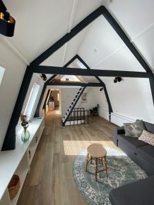 a living room with a couch and a table at Appartement Oldenburg in Bergen