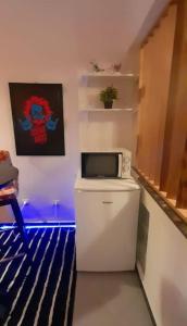 a small kitchen with a microwave on top of a refrigerator at Zen Studio in Rabat