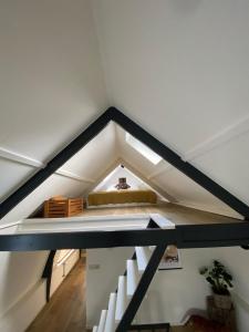 a loft with a bed in the middle of a room at Appartement Oldenburg in Bergen