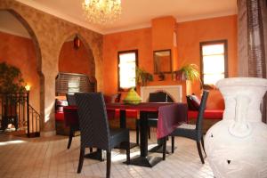 a dining room with a red table and chairs at Chambre Meknes, Riad 7 au village naturiste Couple only in Cap d'Agde