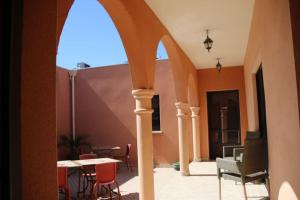 an archway in a building with chairs and tables at Chambre Meknes, Riad 7 au village naturiste Couple only in Cap d'Agde