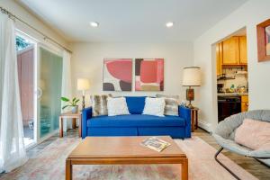 a living room with a blue couch and a table at Beautiful Boulder Townhome Walk to CU and Pearl St! in Boulder
