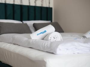 einen Stapel Handtücher auf dem Bett in der Unterkunft Dream Team Bocianowo in Bydgoszcz