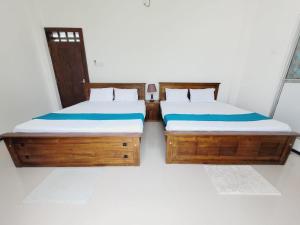 Postel nebo postele na pokoji v ubytování Vidushi Home