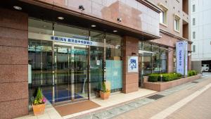 鹿児島市にある東横INN鹿児島中央駅東口のガラスのドアが付いた建物の店先 +64枚の写真