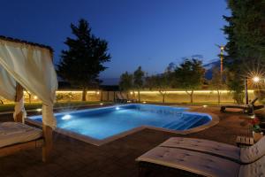 a swimming pool in a backyard at night at Holiday Home Giardino Marino in Pomer