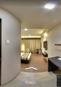 a hotel room with a bed and a couch at Hotel Signature in Ichalkaranji