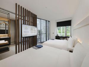 Katil atau katil-katil dalam bilik di Orient Luxury Hotel-Jiaoxi