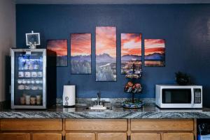 a kitchen with a counter with a microwave and a counter sidx sidx at Travelodge by Wyndham Worland in Worland