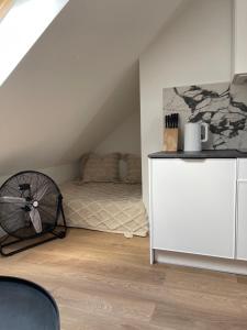 a bedroom with a bed and a white dresser at Slow Home in Dziemiany