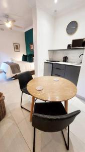 a room with a table and two chairs and a bed at Modern studio with private garden, self check-in in Johannesburg