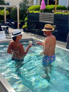 a man and a woman in a swimming pool at Hotell Dannegården in Trelleborg