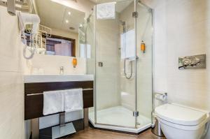 a bathroom with a shower and a toilet at Hotel Swing in Kraków