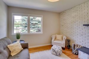 a living room with a couch and a chair at Modern Rapid City Vacation Rental with Deck in Rapid City