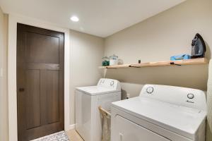 a small laundry room with a washer and dryer at Modern Rapid City Vacation Rental with Deck in Rapid City +21 photos