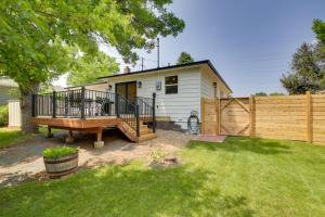a small white house with a wooden fence at Modern Rapid City Vacation Rental with Deck in Rapid City