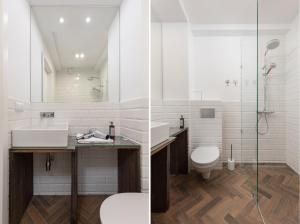 a bathroom with a sink and a shower and a toilet at ECRU Warsaw Apartment near Vistula River WWA1 in Warsaw