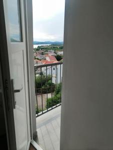 an open door with a view of a balcony at Studio apartman Laca in Šibenik