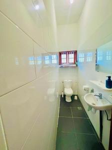 a bathroom with a toilet and a sink at Belle villa avec rooftop sur la plage in Cotonou