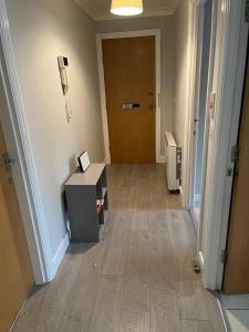 an empty room with a hallway with a desk and a door at Ferry Gait in Edinburgh