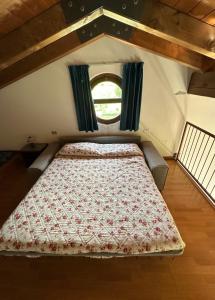 a bed in a small room with a window at Agriturismo Fioravante in San Pietro in Cariano